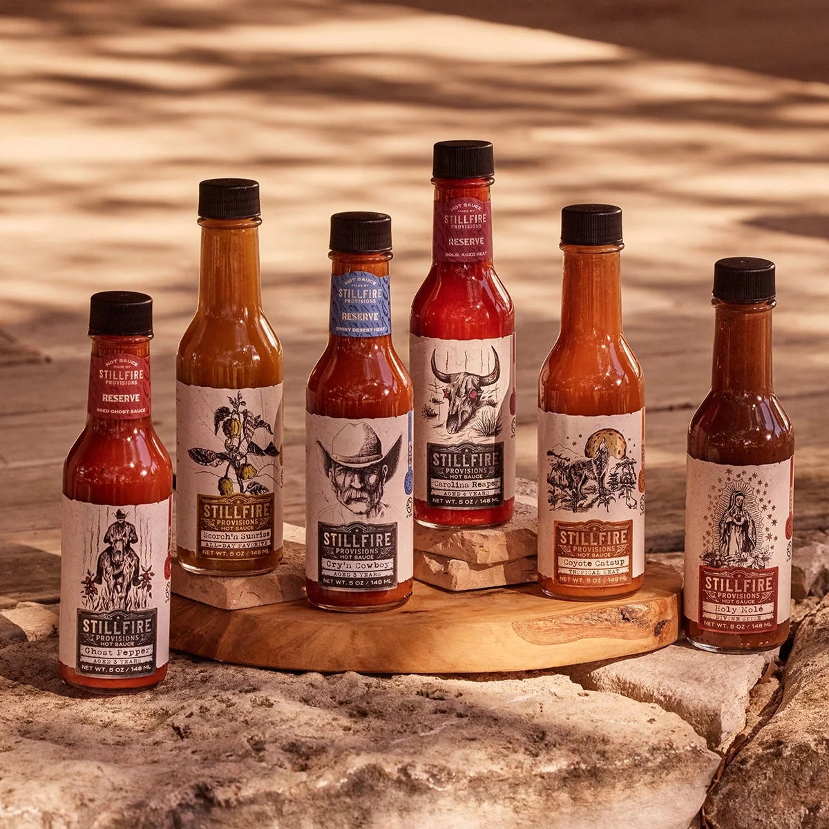 bottle of Stillfire Provisions hot sauces with vibrant labels, perfect for spicy food lovers