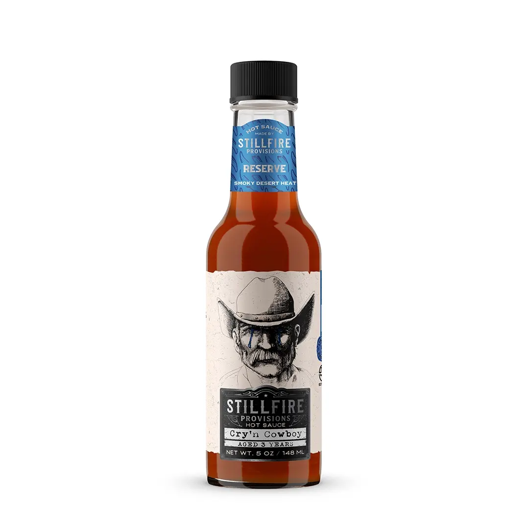 Bottle of Stillfire Provisions Cryin Cowboy sauce on a white background