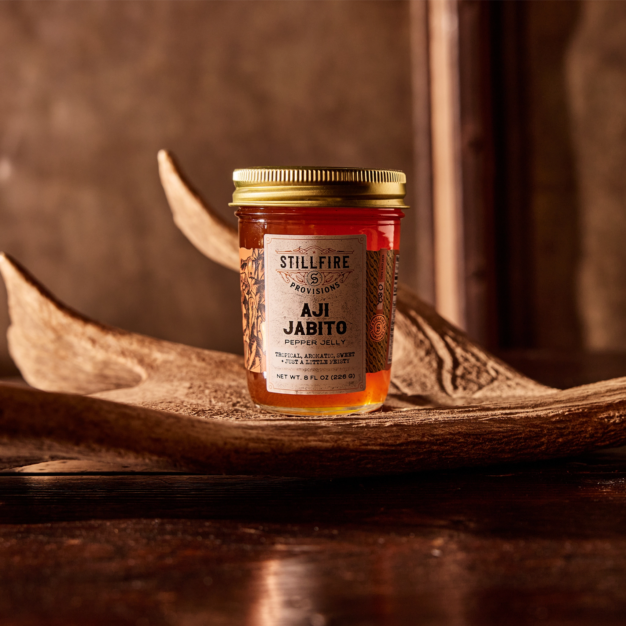 Aji Jabito Hot Sauce on elk antler on a wood table.