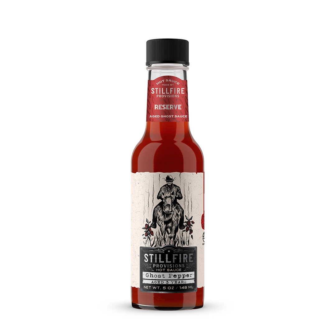 Bottle of Stillfire Provisions Ghost Pepper sauce on a white background