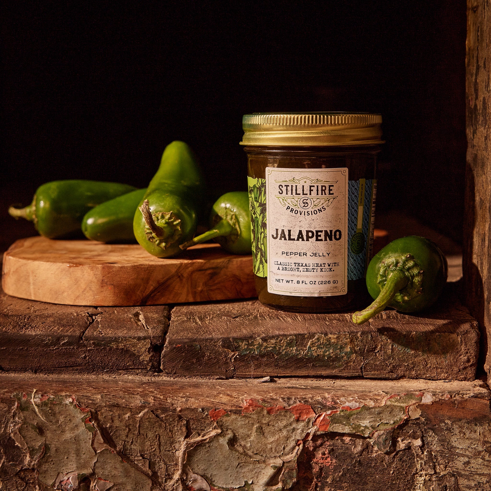 Jalapeno Pepper Jelly next to Jalapeno Peppers on a cutting board