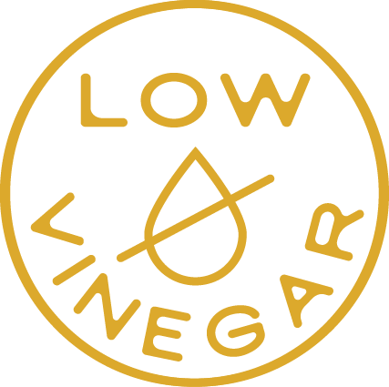 Gold 'LOW VINEGAR' logo with a droplet symbol on a white background