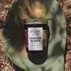 Carolina Reaper Pepper Jelly in a jar, shown on a cactus-themed background.