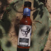 Cry'n Cowboy hot sauce, shown on a cactus-themed background.