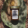 Mango Habanero Pepper Jelly in a jar, shown on a cactus-themed background.